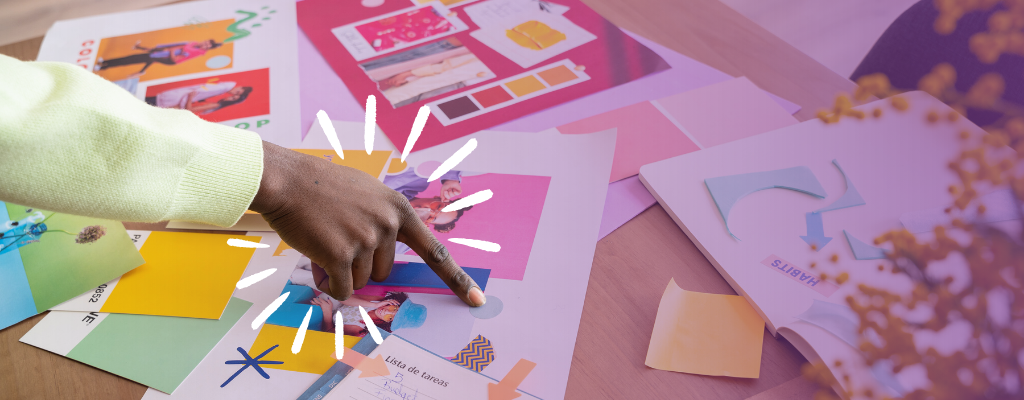 A person gently touches a colorful piece of paper, showcasing vibrant hues and textures.