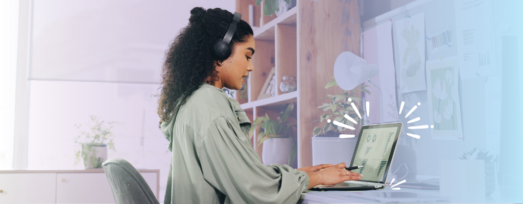A woman wearing headphones focuses on her laptop, engaged in nonprofit email marketing tasks to connect with donors.